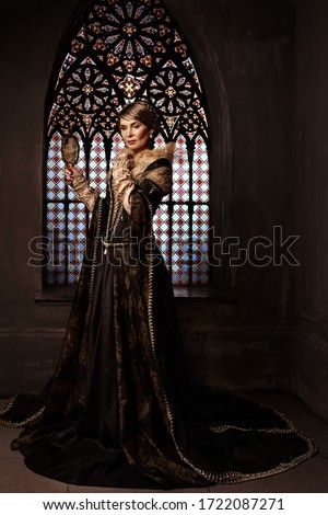 Mature woman in costume of queen