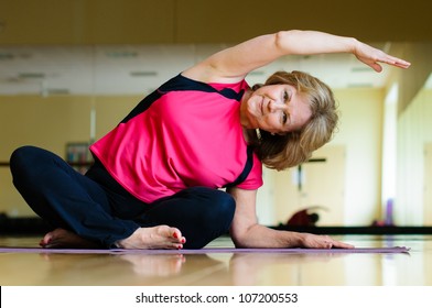 Mature Woman Does Yoga Side Bend