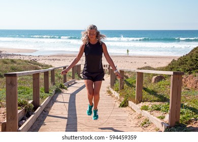 Mature Woman Doing Basic Jump With A Jumping Rope