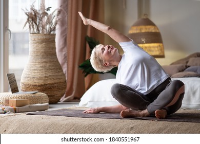 Mature Woman Doing Stretching Yoga Side Bend At Home.