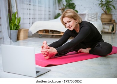 Mature Woman Doing Workout Online On Laptop