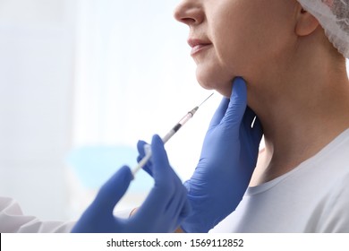 Mature Woman With Double Chin Receiving Injection In Clinic, Closeup