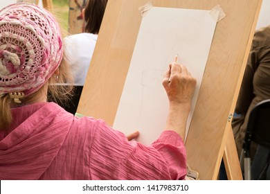 Mature Woman Draws Floral Sketch In Art Studio Outdoor. Moscow - June 1, 2019. Authentic Hobby. Topic For Creativity, Hobby For Retired People, Social Programs For Elderly People. Selective Focus