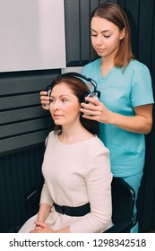 Mature Woman During Hearing Test At Audiologist Office