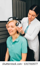 Mature Woman During Hearing Test At Audiologist Office