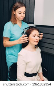 Mature Woman During Hearing Test At Audiologist Office