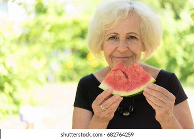 Mature Woman Eating Watermelon.