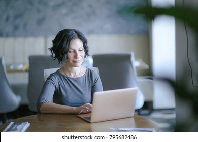 Mature Woman Enjoys A Laptop 