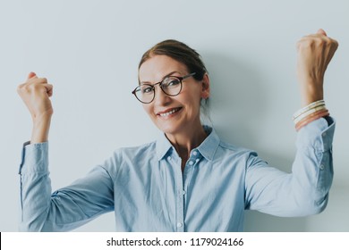 Mature Woman Excited Not Isolated On Grey Background.Surprised Happy Beautiful Woman Looking In Excitement.Surprised Woman With Hands Up Amazed. Looking At Camera. Happy Teacher.