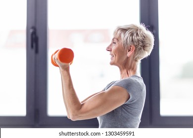 Mature Woman Exercise With Weight On Hands