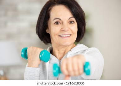 Mature Woman Exercising With Dumbells