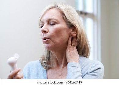 Mature Woman Experiencing Hot Flush From Menopause