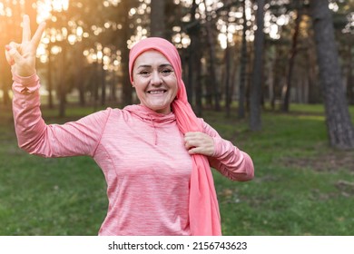 mature woman fighting cancer with a pink scarf on. nature at sunset - breast cancer survivor concept - - Shutterstock ID 2156743623