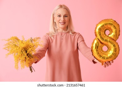 Mature Woman With Flowers And Balloon In Shape Of Figure 8 On Pink Background. International Women's Day