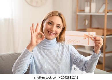 Mature Woman With Gift Card Showing OK At Home