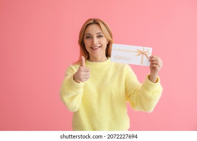 Mature Woman With Gift Card Showing Thumb-up On Color Background