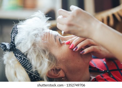 Mature Woman Gives The Eye Drops Herself At Home.