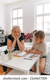 Mature Woman Granny With Grandchild Preschool Girl Drawing Together At Home. 