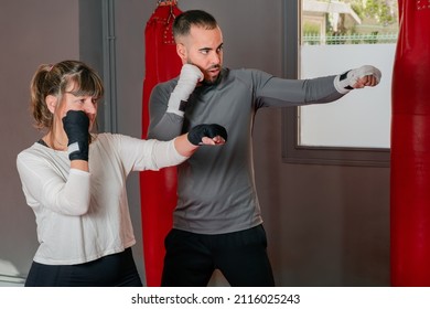 Mature Woman At The Gym In Boxing Class With Her Teacher