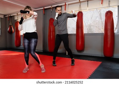 Mature Woman At The Gym In Boxing Class With Her Teacher