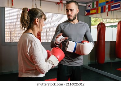 Mature Woman At The Gym In Boxing Class With Her Teacher