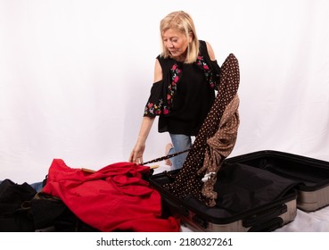 Mature Woman Happy With Her Clothes Shopping In The Sales With A White Background