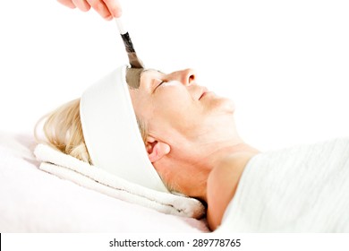 Mature Woman Having Beauty Skin Treatment, Beautician Applying Clay Mask