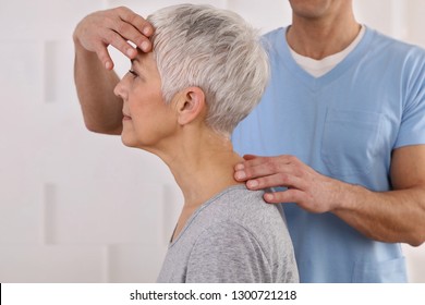 Mature Woman Having Chiropractic Adjustment. Osteopathy, Physiotherapy, Acupressure, Holistic Care. Craniosacral Therapy
