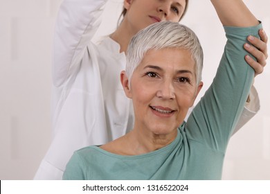 Mature Woman having chiropractic back adjustment. Osteopathy, Physiotherapy, Sport injury rehabilitation concept, holistic care - Powered by Shutterstock