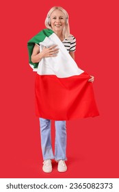 Mature woman in headphones with flag of Italy on red background - Shutterstock ID 2365082373