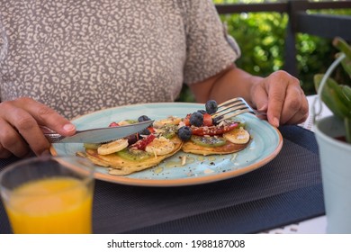 Mature Woman With Healthy Summer Breakfast, Classic American Pancakes With Banana, Kiwi, Fresh Berry And Honey