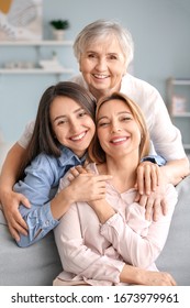 Mature woman with her adult daughter and mother spending time together at home
