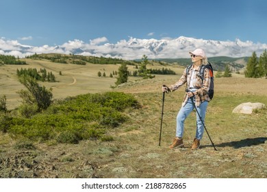  Mature Woman Hiker With Backpack Using Poles,  Hiking In Mountains.