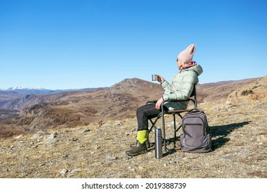 Mature Woman Hiker Drinking Tea At Autumn Mountains. Activity Lifestyle Concept.