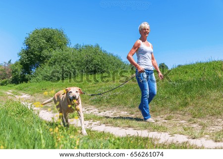 Similar – Image, Stock Photo Attractive womanon a rural path with dogs at sunset