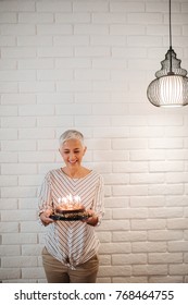 Mature Woman Holding A Birthday Cake