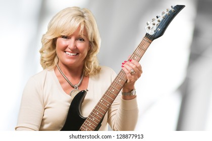 Mature Woman Holding Guitar, Indoor