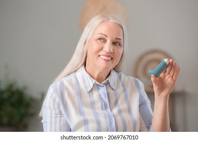 Mature Woman With Inhaler Having Asthma Attack At Home