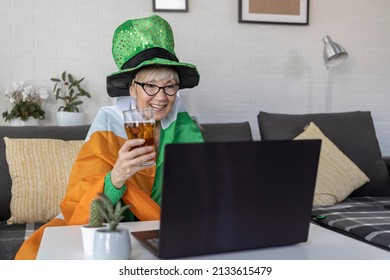 Mature Woman With Irish Flag On Shoulders Holding Glass Of Beer And Celebrate Saint Patrick Day