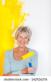 Mature Woman Keeping Busy, While Painting Her Walls