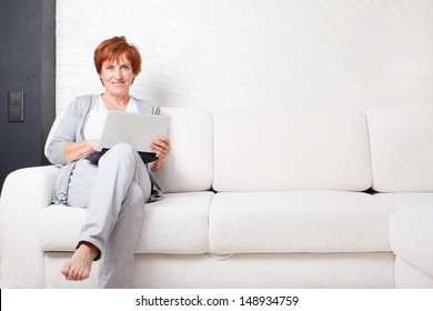 Mature Woman With  Laptop. Female With Computer At Home