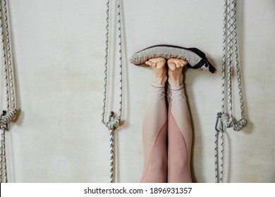 Mature Woman Laying Next To The Wall With Her Feet Up With Sand Bags On Top