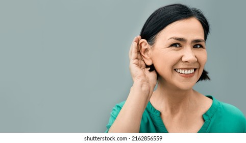 Mature Woman Listening Sound With Hand Near Ear For Hearing Check-up. Hearing Test Concept