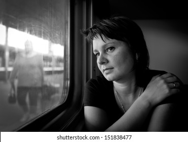 Mature Woman Looking Into The Window Of The Train. Real People Series.