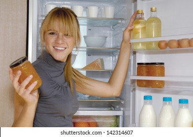 Mature Woman Looking For Something In The Fridge At Home