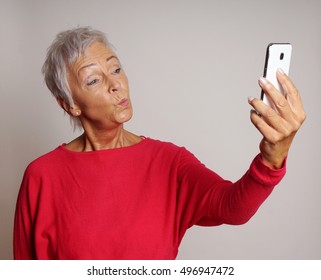 Mature Woman Making A Duck Face While Taking A Selfie With Her Smartphone