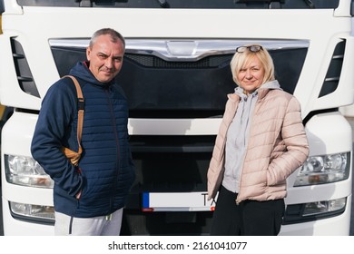 Mature Woman And Man As Couple Parters Truck Drivers. Transportation Workers In Europe