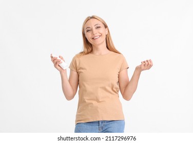 Mature Woman With Mosquito Repellent On Light Background