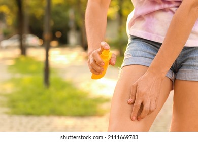 Mature Woman With Mosquito Repellent In Park