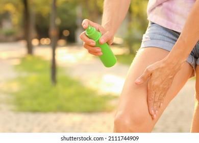 Mature Woman With Mosquito Repellent In Park